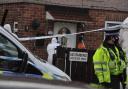 Police and forensic officers investigate a house in Shirley Grove, in the Lightcliffe area