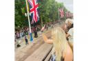 Katie Ormerod waves to the crowd on the Mall of Buckingham Palace