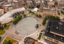 A view of Bradford city centre, showcasing City Park, the Mirror Pool, Bradford Magistrates' Court and City Hall