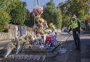 A police community support officer lays a floral tribute at the scene in Woodhouse Hill, Huddersfield, where 15-year-old schoolboy Khayri McLean was fatally stabbed outside his school gates