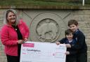 Becki Marren, of Candlelighters, receives the cheque from Isabella and Stephen Beck