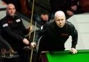 David Grace (left) spent most of his first-round match against John Higgins sat in his chair, with the Scot imperious in his 10-3 win over the Bradfordian.