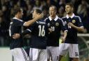 Ross McCormack celebrates a goal for Scotland in August 2012, with Andy Webster, Charlie Adam and Charlie Mulgrew
