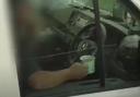 Watch the moment police catch driver sipping mug of tea with hands off the wheel