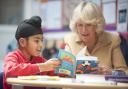 Literacy charity Beanstalk’s patron the Duchess of Cornwall offers some reading help to a young pupil
