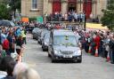 Mourners throw flowers and applaud as the coffin of Labour MP Jo Cox passes in Batley