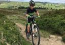 Keelham Primary School pupil Ryden Hindle on his way to gold and silver in the regional and national mountain bike event at wild and windy Penistone Hill Country Park in Haworth