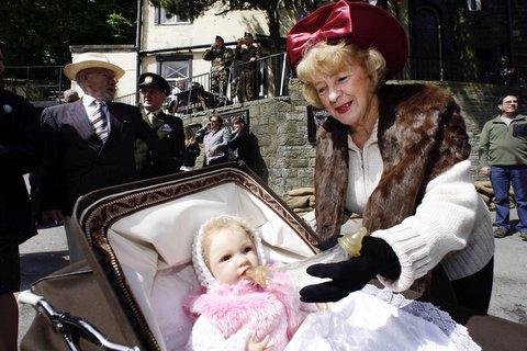 Mavis Hoyle takes care of a baby during the Haworth 1940s Weekend.