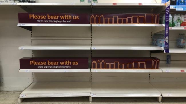 Sainsbury's and Tesco 'disguise' empty shelves with cardboard food . (PA)