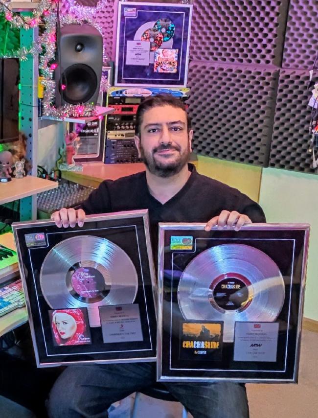 Harry Bhangal is celebrating two of his hits, Cha Cha Slide and a remix of a Kelly Clarkson Christmas smash, have each gone platinum