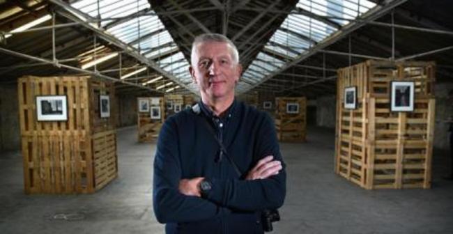 Photographer Ian Beesley in 2017 in the exhibition of images he made during the changes at Salts Mill during the final years of production in the 1980s