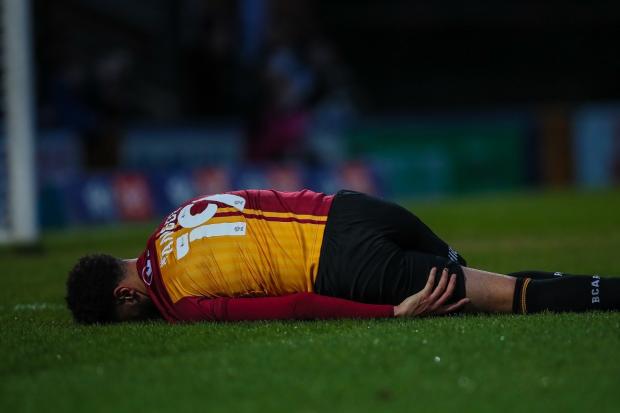 Bradford Telegraph and Argus: Lee Angol on the turf after suffering a nasty hamstring injury in the game at Rochdale in January.