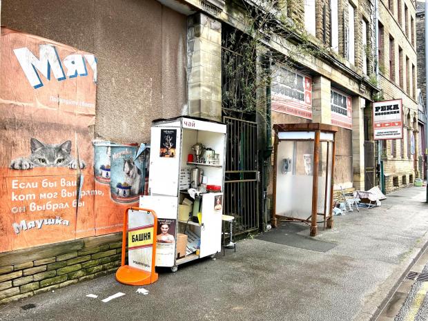 Bradford Telegraph and Argus: Posters, a phone box and shop signs are among the props set up in Canal Road. Picture: Mark Davis