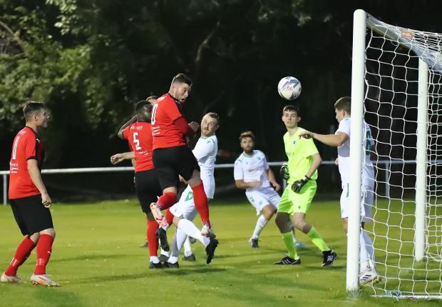 Bradford Telegraph and Argus: Campion captain Aidan Kirby (red, jumping) could not lead his team to a win over Golcar United, as the Bradford side went down 3-2 in a cracking contest. Picture: Alex Daniel.