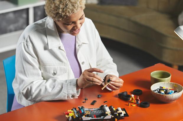 Bradford Telegraph and Argus: A woman putting together the LEGO Delorean. Credit: LEGO