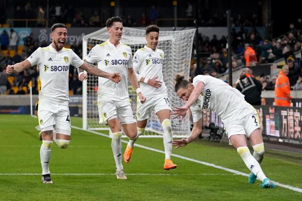 Joy unconfined for Luke Ayling (right) and his Leeds United teammates after his last-gasp winner at Wolves on Friday night. Picture: Nick Potts/PA Wire.