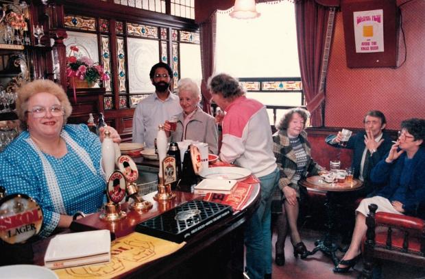 Bradford Telegraph and Argus: Manageress Roni Breakwell pulling a pint behind the Cock and Bottle bar in 1988