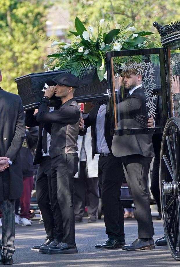 Bradford Telegraph and Argus: Max George and Jay McGuiness of The Wanted carry the coffin at the funeral of their bandmate. (PA)