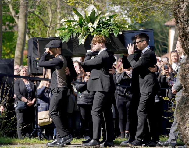 Bradford Telegraph and Argus: Max George (left) and Jay McGuiness of The Wanted (centre) carry the coffin at the funeral of their bandmate Tom Parker. (PA)