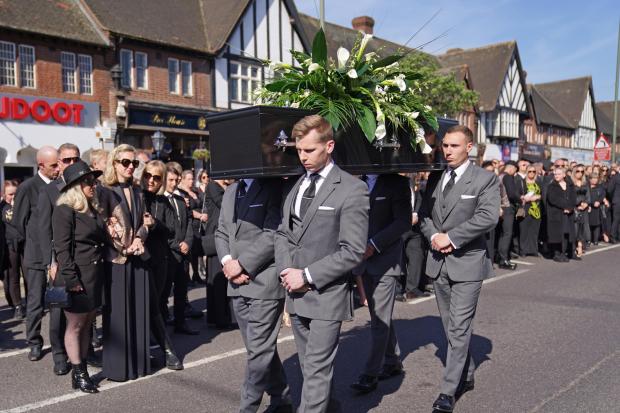 Bradford Telegraph and Argus: The coffin of The Wanted star Tom Parker is carried ahead of his funeral. (PA)