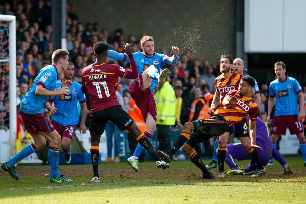 Bradford Telegraph and Argus: Tim Dieng shoots as City lay seige to Scunthorpe's goal in a TV thriller in 2017