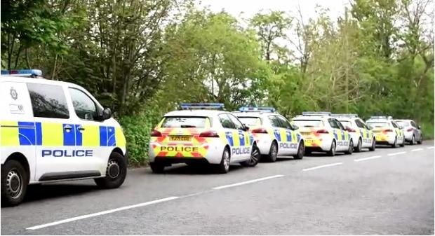 Bradford Telegraph and Argus: Several police cars are at the scene on land off Pudsey Road