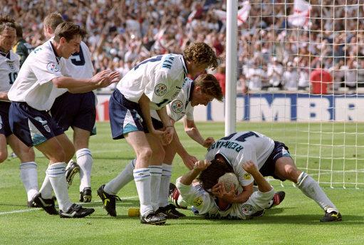 Bradford Telegraph and Argus: Paul Gascoigne, bottom, is mobbed by team-mates after his remarkable goal against Scotland during Euro '96 