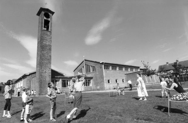Bradford Telegraph and Argus: Playing rounders outside St Aiden's Church, Buttershaw, in 1993