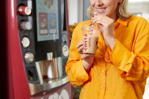 Bradford Telegraph and Argus: A person holding a cold drink in front of a new Costa Express machine (Costa Coffee)