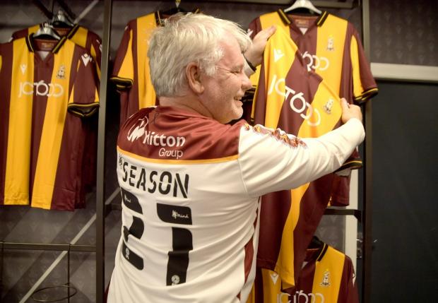 Bradford Telegraph and Argus: Supporter David Coleman gets his hands on the new Bradford City home shirt supplied by sportswear firm Macron