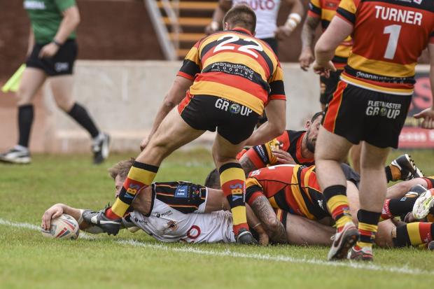 Chester Butler stretches over for his second try. Picture: Tom Pearson