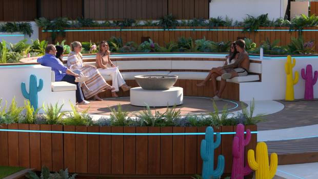 Bradford Telegraph and Argus: Gemma and Luca at the fire pit with their families. Love Island continues tonight at 9pm on ITV2 and ITV Hub. Episodes are available the following morning on BritBox. Credit: ITV