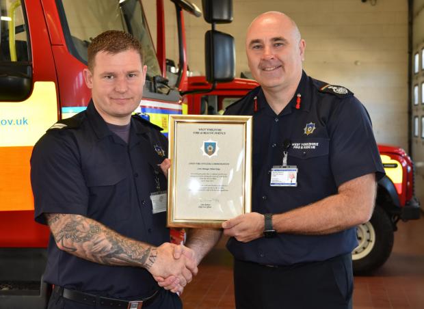 Bradford Telegraph and Argus: Keighley White Watch Firefighter Adam Dykes with West Yorkshire Fire & Rescue Service's (WYFRS) Chief Fire Officer, John Roberts. Picture: WYFRS