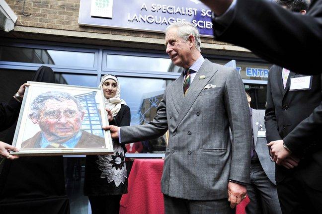 Prince Charles receives an acrylic 3D portrait of himself painted by top A-level student Rizwana Bibi, 17, pictured centre.