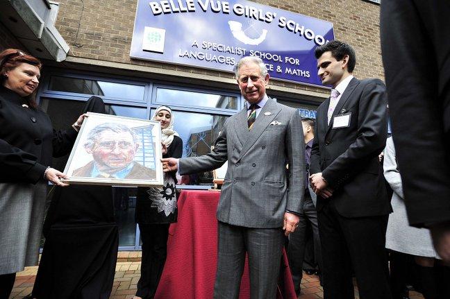 Belle Vue Girls' School head teacher Mary Copeland presents Prince Charles with an acrylic 3D portrait of himself painted by top A-level student Rizwana Bibi, 17, pictured centre.