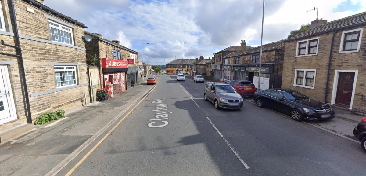 Police scene on Bradford road after wanted man is found with 'gun' 