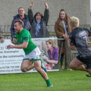 Wharfedale's Rian Hamilton wins a foot race to the try line. Picture: Ro Burridge