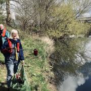 Maureen Pinder and Nigel Smith litter picking along the banks of the River Aire