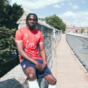 Clayton Donaldson poses in the new York strip - but his contract does not begin until next month