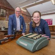 William Gaunt and Rachel Moaby with a comptometer, which was the first mechanical calculator used in the mill office, in the foreground and a crockmeter that tests the colour of the dye