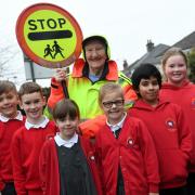 School crossing patrol Betty Timbrell, who is retiring at the age of 88, with pupils at Eldwick Primary School