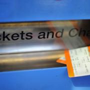 Photo shows tickets being obtained from a machine.