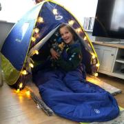 Halle, of the Ninth Bradford North Scout Group, camps at home