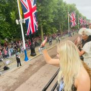 Katie Ormerod waves to the crowd on the Mall of Buckingham Palace