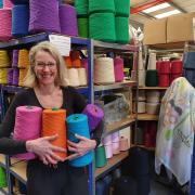 Joanne with the many colourful yarns on sale