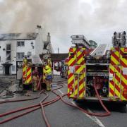 The pub engulfed in fire. Picture by Martyn Hughes, fire service