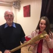 Mike Healey, pictured presenting the replica Olympic torch to East Bradford Cycling Club's Florence Greenhalgh, will be carrying the Queen's Baton later this month ahead of the Commonwealth Games.