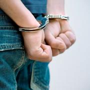 A generic picture of a person in handcuffs