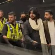 Screenshot shows singer Zeeshan Khan Rokhri leaving Life Church, on Wapping Road, as police escorted attendees out of the venue