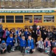 Tehseen with children outside the Bradford Stories Bus in City Park